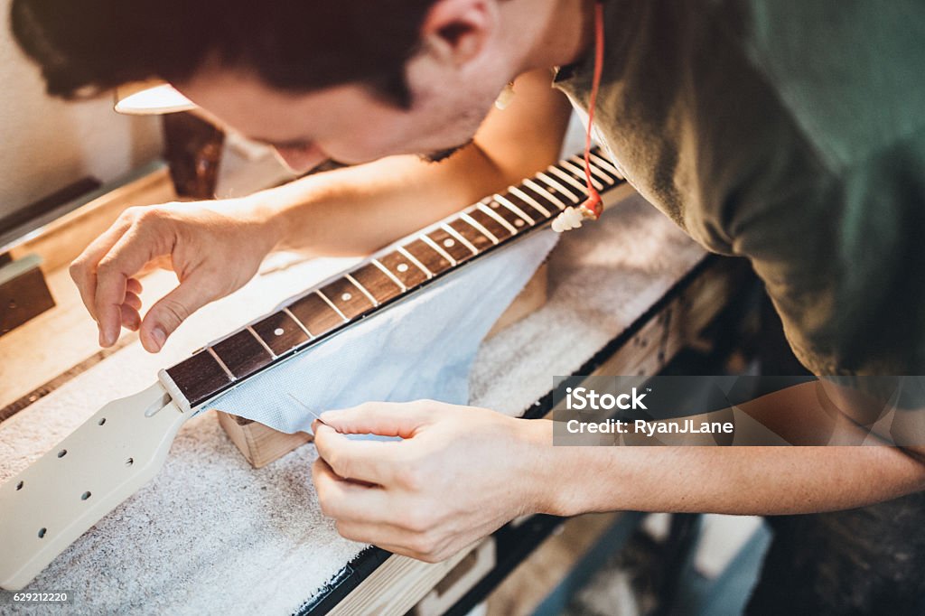 Luthier working on a guitar in a workshop